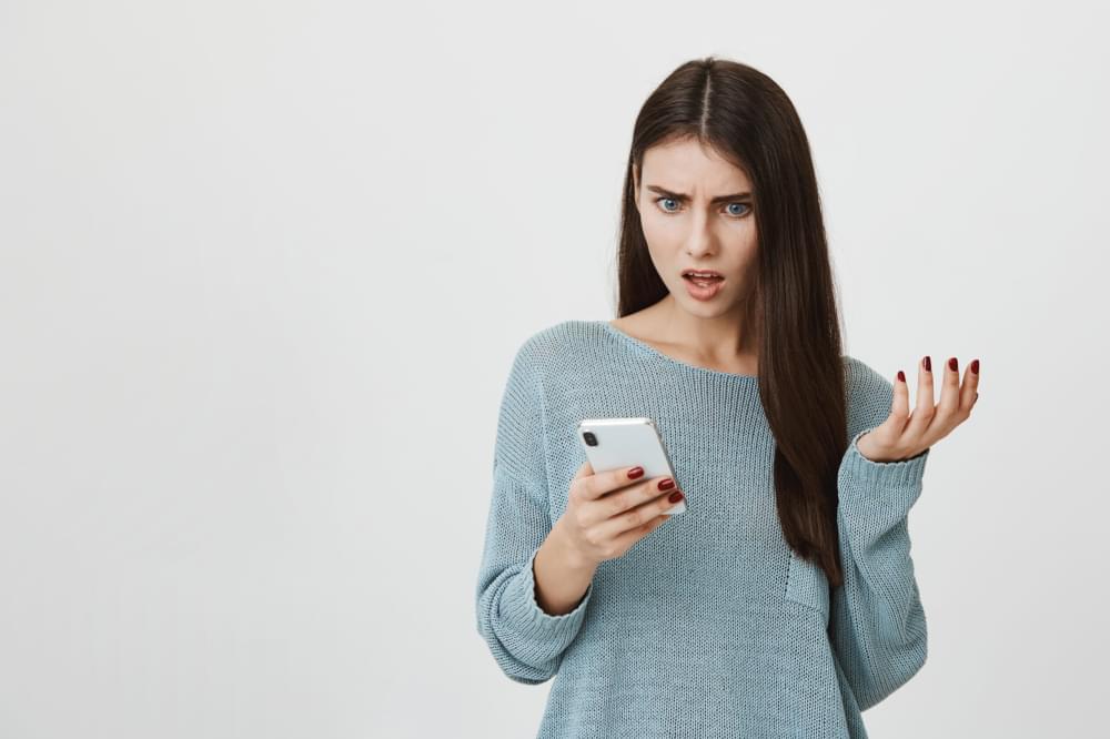 Frustrated-shocked-woman-stare-at-mobile-phone-upset-scaled-1.jpg