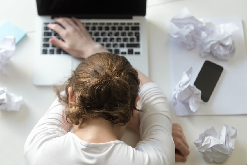 Top-view-portrait-of-woman-lying-at-desk-near-the-laptop.jpg